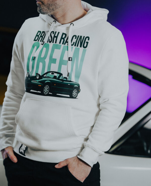 Close-up of a person wearing a white Miata racing hoodie with a graphic of a Mazda Miata car, highlighting automotive enthusiast apparel.