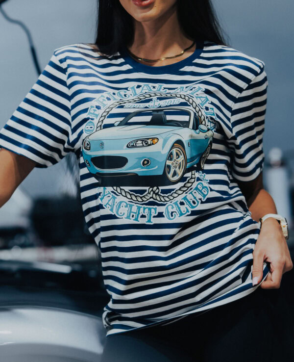 Woman wearing a Miata-themed striped T-shirt with a car graphic, representing the MiataNight Club, perfect for Mazda Miata enthusiasts.
