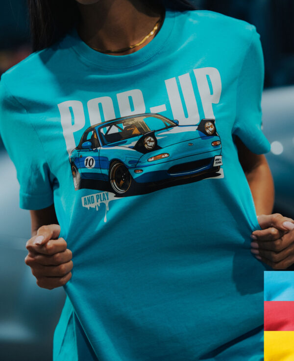 Blue T-shirt featuring a graphic of a Mazda Miata with "POP-UP" text, perfect for car enthusiasts and Miata fans.